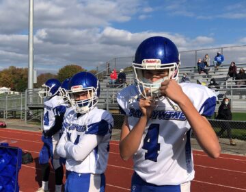 Players on the sidelines also wore their masks and kept some distance from each other. (Cris Barrish/WHYY)