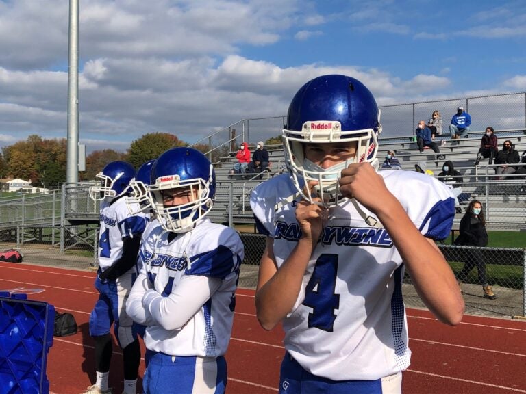 Players on the sidelines also wore their masks and kept some distance from each other. (Cris Barrish/WHYY)