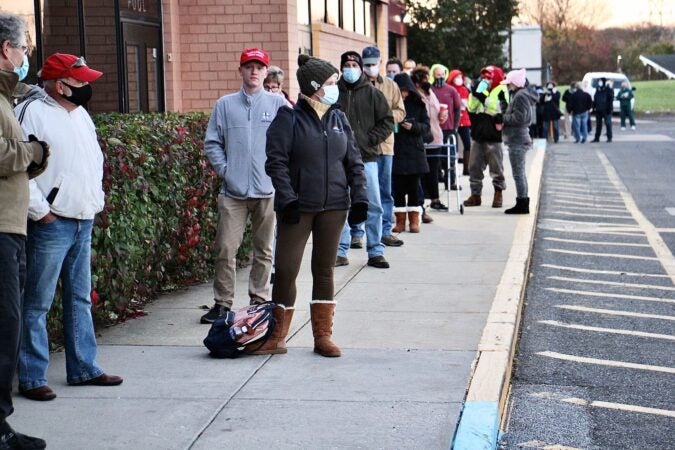 People line up to vote outside a middle school