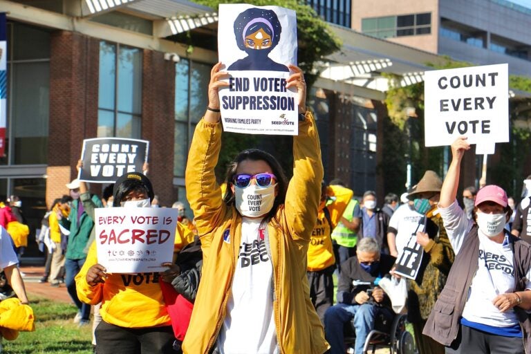 Protesters raise signs at the Count Every Vote rally on Independence Mall. (Emma Lee/WHYY)