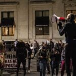 YahNé Ndgo leads protesters in chanting Walter Wallace Jr.’s name at City Hall after the city of Philadelphia released bodycam footage of his fatal shooting. (Kimberly Paynter/WHYY)