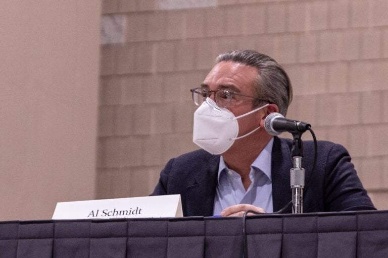 Philadelphia City Commissioner Al Schmidt wears a mask while sitting at a table