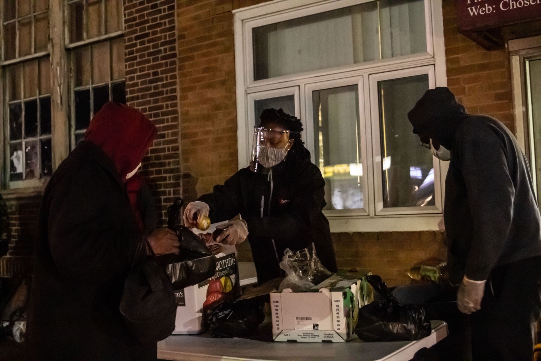 Sherica Douglas hands out fresh fruit with hot food at the Chosen 300 Ministries.