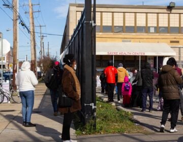 People stand in line outside Sayre Health Center for COVID testing a week before Thanksgiving in West Philadelphia. (Kimberly Paynter/WHYY)