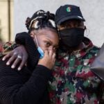 Sam White, cousin of Walter Wallace Jr., comforts his widow, Dominique Wallace, at a press conference at City Hall Friday. (Kimberly Paynter/WHYY)