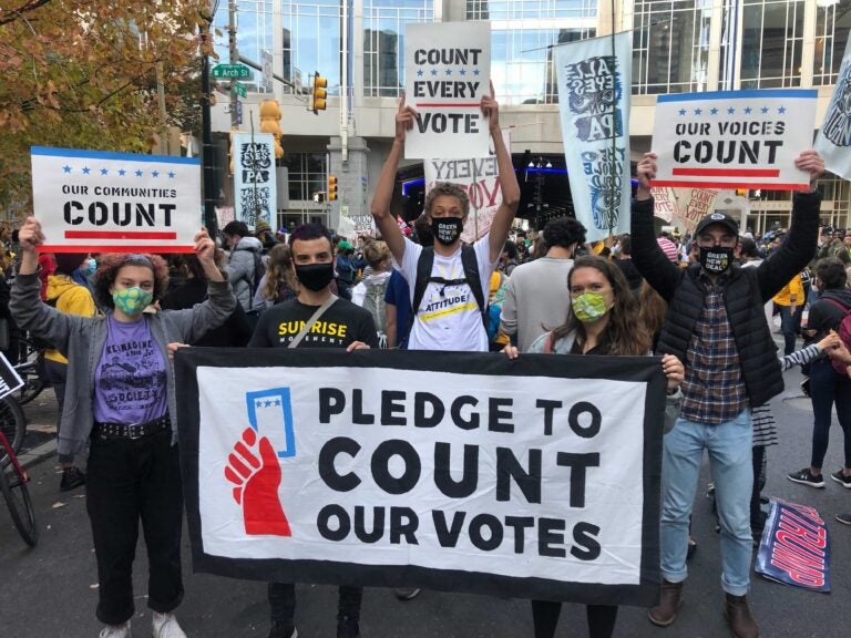 Ed Brown (center in group photo), 17, stands with friends and Sunrise members at the Count Every Vote rally Thursday (Miles Bryan / WHYY)