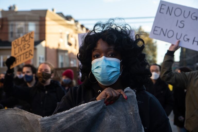 Ebony Powell is the organizer of the “Enough is Enough” campaign. University of Pennsylvania students marched to UPenn’s campus in protest of the school’s lack of investment in the community and over-policing. (Kimberly Paynter/WHYY)