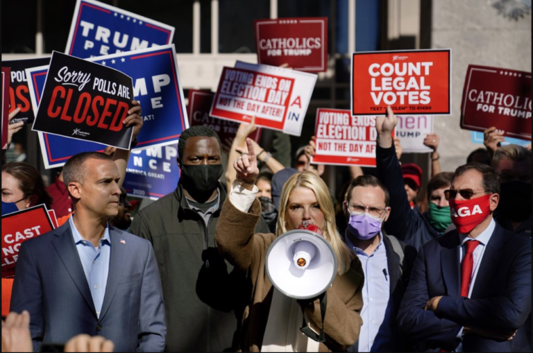 Former Florida Attorney General Pam Bondi speaks about a court order granting President Donald Trump's campaign more access to vote counting operations at the Pennsylvania Convention Center, Thursday, Nov. 5, 2020, in Philadelphia, following Tuesday's election. At left is Trump campaign advisor Corey Lewandowski. (AP Photo/Matt Slocum)