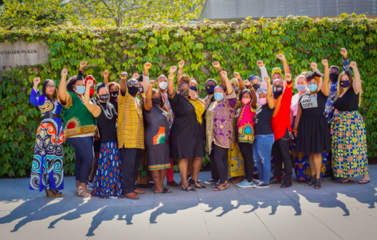 Mary McLeod Bethune Elementary principal Aliya Catanch-Bradley raises her fist with her staff during a recent birthday photoshoot at the Barnes Foundation. (Aliya Catanch-Bradley)