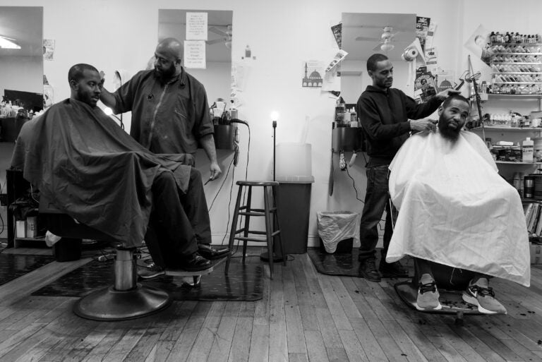 G and his colleague both cutting the hair of clients. (Photo by Antonio Johnson/Produced at Gamin’ Cutz in Philadelphia, PA. December 2019.)