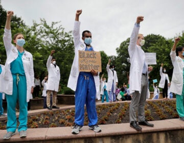 Healthcare professionals gather outside Barnes-Jewish Hospital in St. Louis to demonstrate in support of the Black Lives Matter movement on June 5. The demonstration, called 'White Coats for Black Lives,' was organized to show solidarity with those protesting the death of George Floyd after being restrained by Minneapolis police officers on May 25.
(Jeff Roberson/AP)