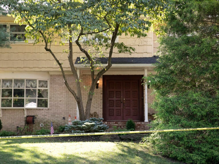 Crime-scene tape surrounds the home of federal Judge Esther Salas in North Brunswick, N.J., on July 20. A gunman shot and killed Salas' 20-year-old son and wounded her husband. (Mark Lennihan/AP Photo)