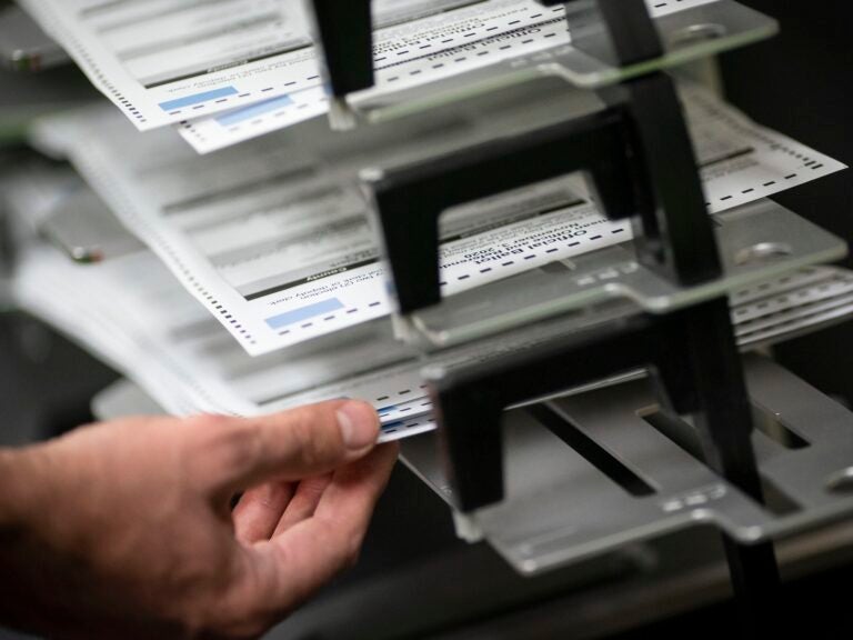 Poll workers sort out early and absentee ballots