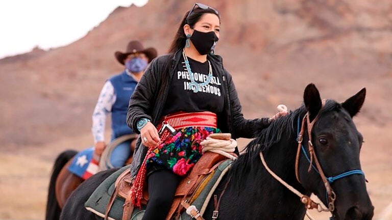 Allie Young, a Diné woman on the Navajo Nation in Arizona, is among a group of Native Americans riding on horseback to the polls on Election Day. (Larry Price/AP)