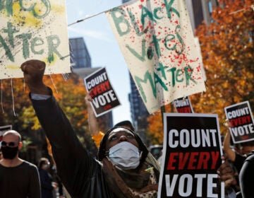 Zhanon Morales, 30, of Philadelphia, raises her fist during a Nov. 5 voting rights rally in Philadelphia.
(Rebecca Blackwell/AP)