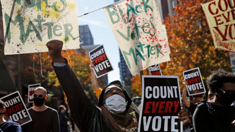 Zhanon Morales, 30, of Philadelphia, raises her fist during a Nov. 5 voting rights rally in Philadelphia.
(Rebecca Blackwell/AP)