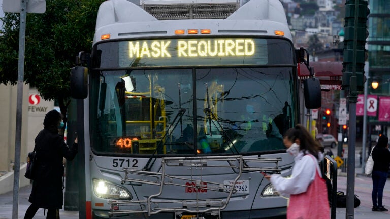 A sign on a bus advises that passengers are required to wear masks. (Jeff Chiu/AP)