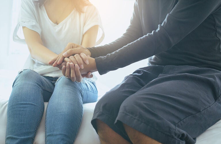 Man giving hand to depressed woman