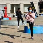 About 25 fitness enthusiasts participate in a protest workout at Thomas Paine Plaza to support gym owners who have been shut down by the coronavirus pandemic.