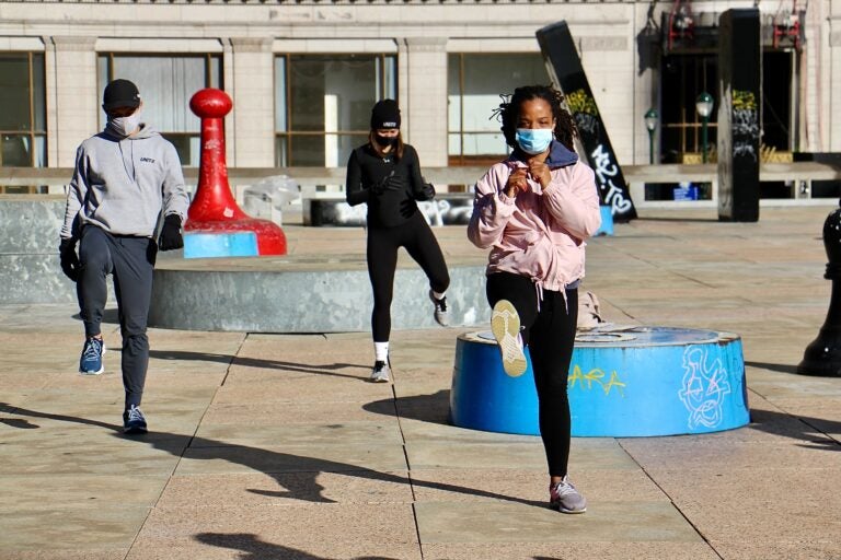 About 25 fitness enthusiasts participate in a protest workout at Thomas Paine Plaza to support gym owners who have been shut down by the coronavirus pandemic.