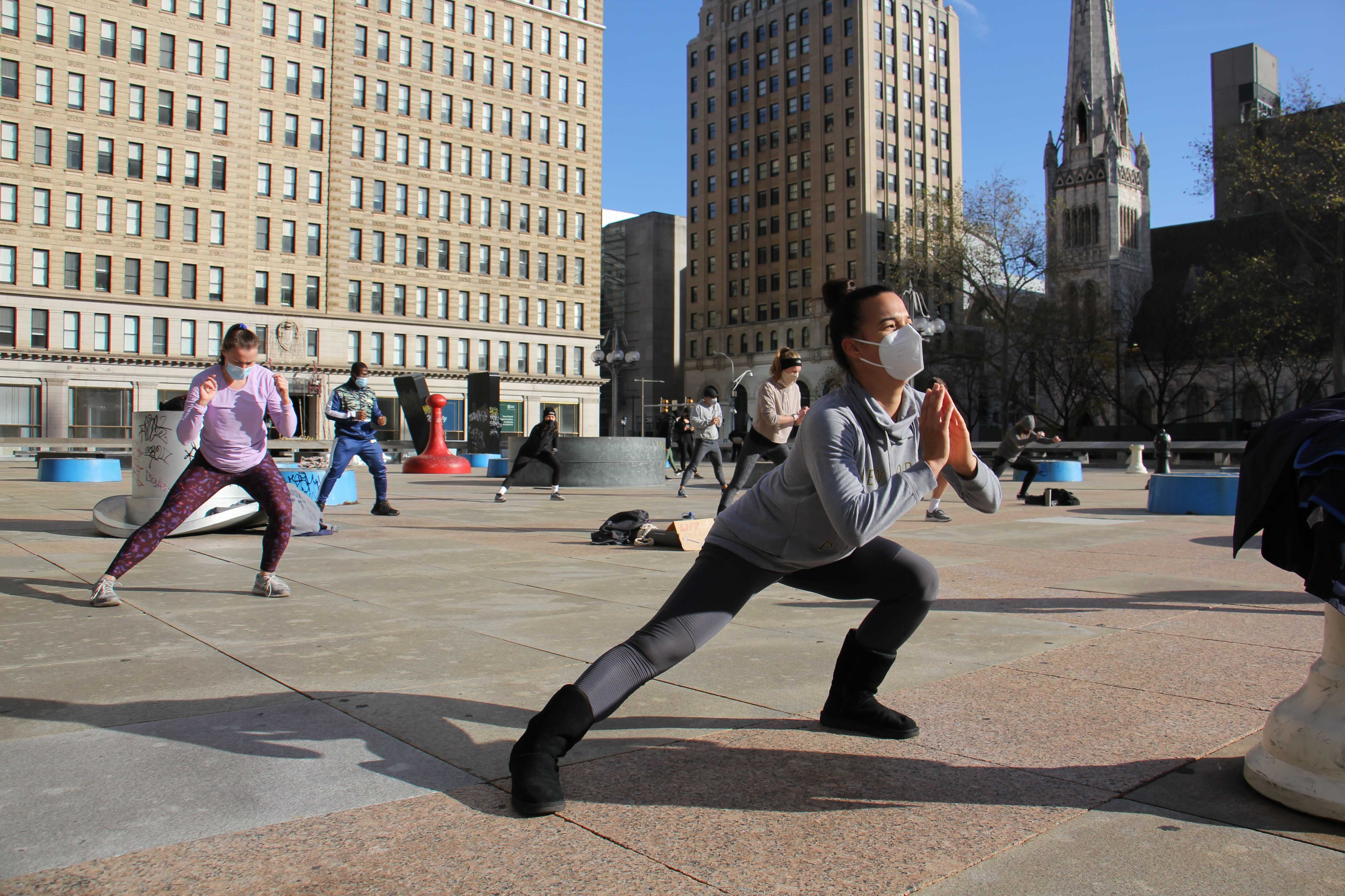 About 25 fitness enthusiasts participate in a protest workout at Thomas Paine Plaza to support gym owners who have been shut down by the coronavirus pandemic.