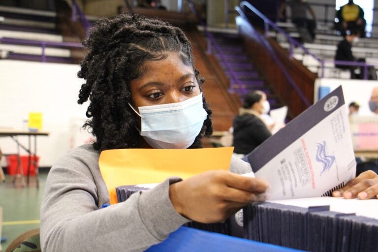 Chester Country election worker Jessica McPherson inspects ballots