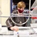 Margaret Hodgkiss-Lilly operates an extractor, which removes ballots from their envelopes