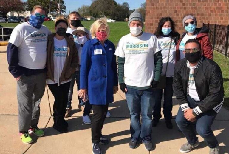 Eric Morrison appears with supporters outside a polling location on Election Day.