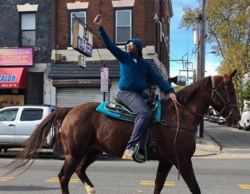13-year-old Nahye Hyman raises a fist on his horse Sally during a GOTV ride down 52nd Street LAYLA A. JONES / BILLY PENN