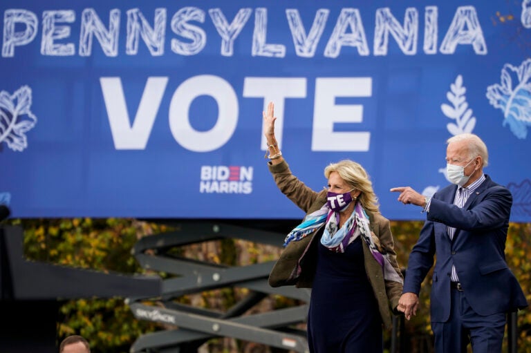 Joe Biden and his wife Jill Biden arrive for a drive-in campaign rally at Bucks County Community College on Oct. 24 in Bristol, Pa. Bucks County and three other suburban Philadelphia counties helped the president-elect win the swing state.