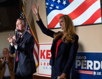 Sens. David Perdue and Kelly Loeffler speak at a campaign event this month at a restaurant in Cumming, Ga. Both are competing in runoff elections in January that will determine which party controls the Senate. (Megan Varner/Getty Images)