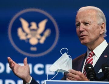 President-elect Joe Biden holds a face mask