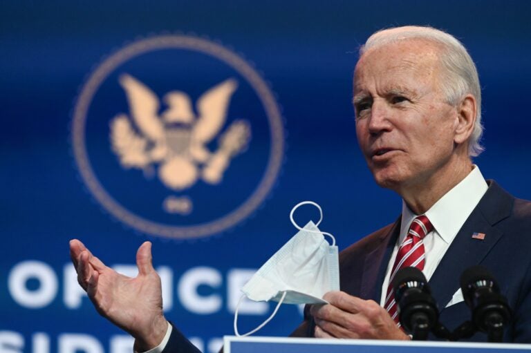 President-elect Joe Biden holds a face mask