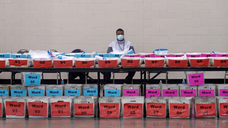 An election official pauses during the ballot recount