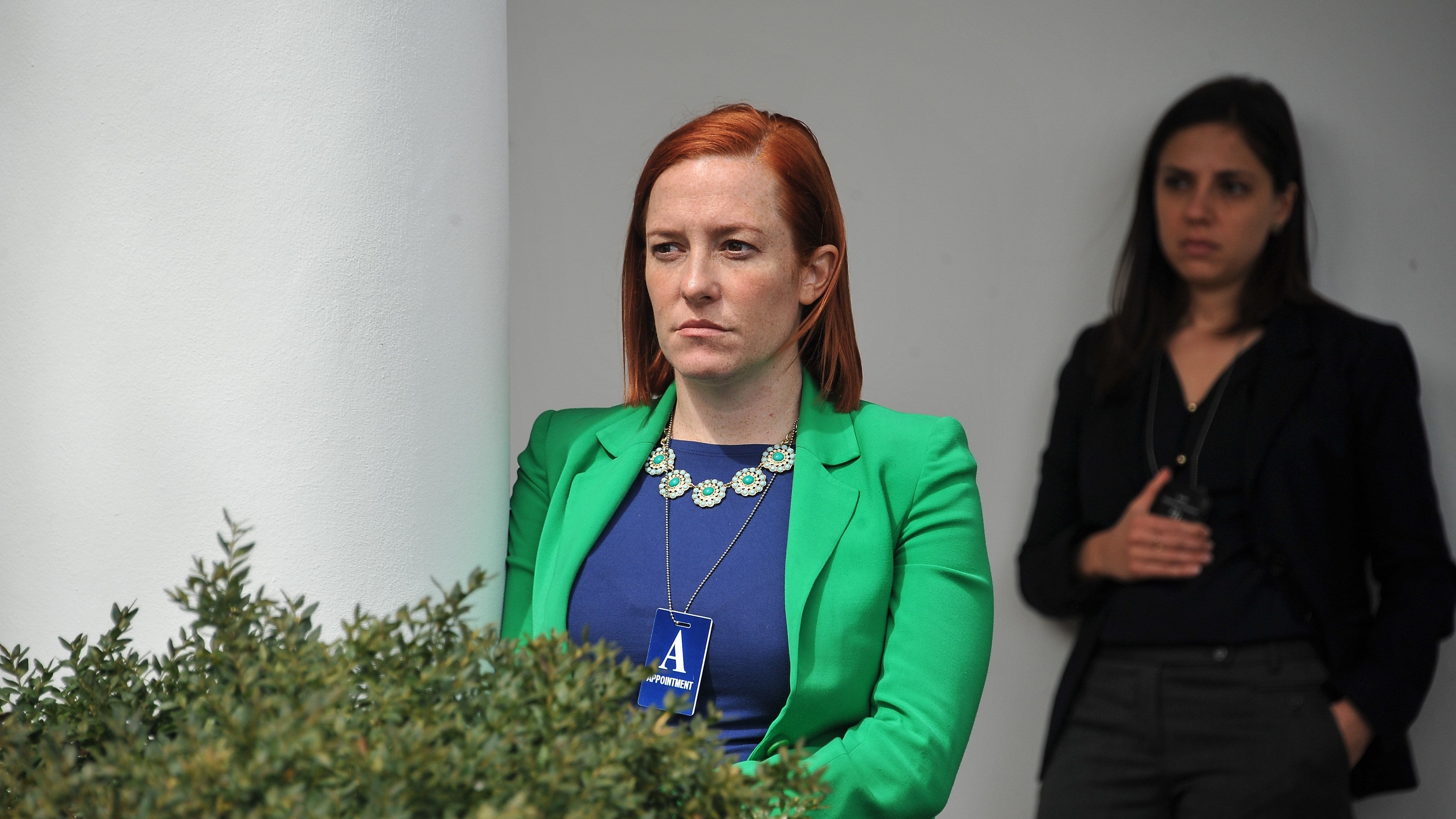 Then-White House Communications Director Jen Psaki listens to President Barack Obam