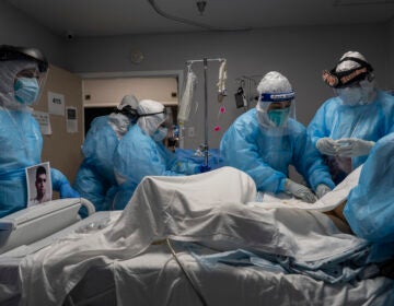 Medical staff members treat a patient with COVID-19 last week in the intensive care unit of United Memorial Medical Center in Houston. Once a COVID-19 vaccine is available, experts say immunizing health workers first is the best way to curb deaths and stop transmission.
