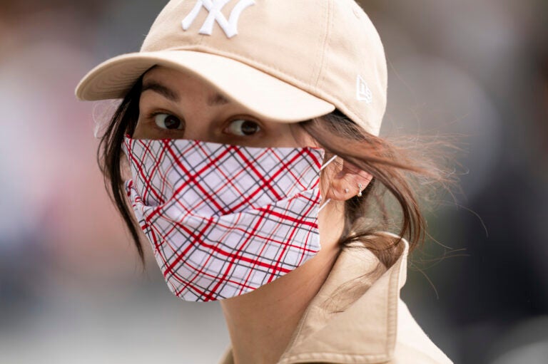 A woman is seen wearing a plaid protective face mask during the coronavirus (COVID-19) pandemic in Washington Square Park on May 24, 2020 in New York City.