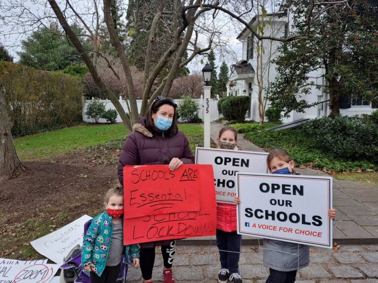 Jennifer Singer with her children, protesting Montgomery County's two-week shutdown