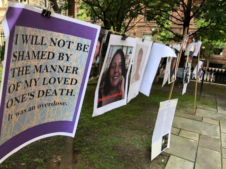 Photographs and words of recovery hang near Trinity Cathedral in downtown Pittsburgh as part of a remembrance of victims during Overdose Awareness Day