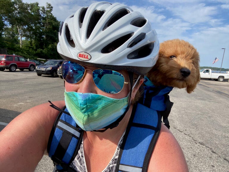 Devin Green rides a bike with her pup Taco