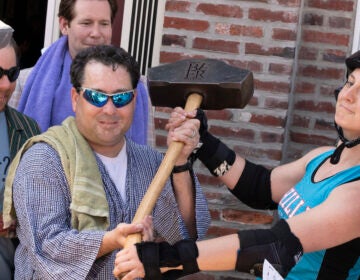 Mike 'Scoats' Scotese (Left) holds the Philly Beer Week Hammer of Glory outside Grey Lodge Pub in 2015. (Danya Henninger/Billy Penn)