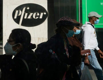 Pedestrians walk past Pfizer world headquarters