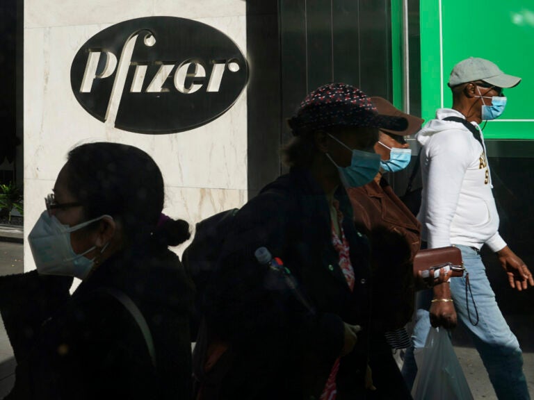 Pedestrians walk past Pfizer world headquarters