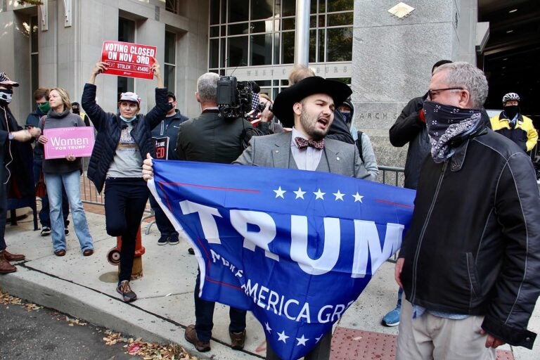 Trump supporters gather in front of the Pennsylvania Convention Center to object to the way votes are being counted there.