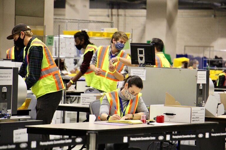 Election workers scan ballots at the Pennsylvania Convention Center.