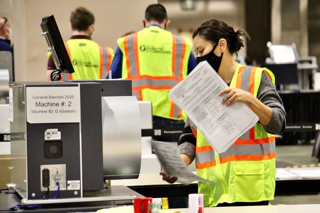 Election workers scan ballots at the Pennsylvania Convention Center.