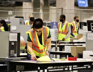 Election workers scan ballots at the Pennsylvania Convention Center. Officials anticipate that the task of scanning mail and absentee ballots will be completed Thursday.