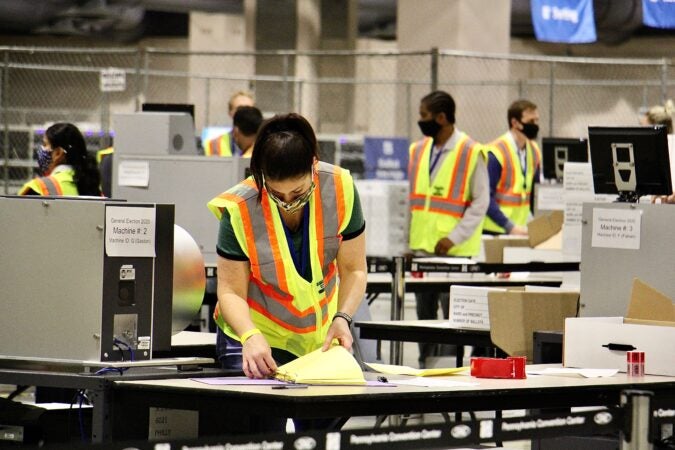 Election workers scan ballots at the Pennsylvania Convention Center. Officials anticipate that the task of scanning mail and absentee ballots will be completed Thursday.