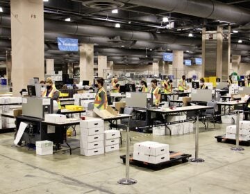 Election workers scan ballots at the Pennsylvania Convention Center. Officials anticipate that the task of scanning mail and absentee ballots will be completed Thursday.