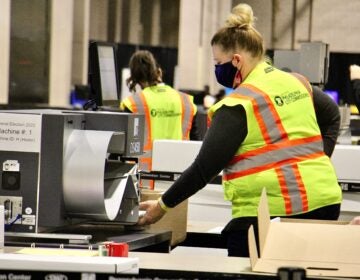 Election workers scan ballots at the Pennsylvania Convention Center. Officials anticipate that the task of scanning mail and absentee ballots will be completed Thursday.